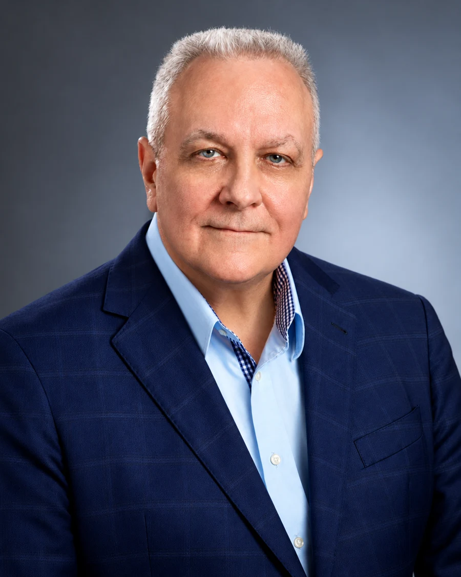John Lupo wearing a navy blazer and light blue shirt